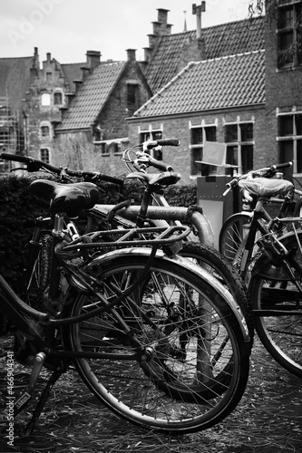 Bikes parked at the side of the road in the rain