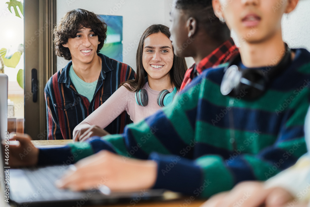 Multiracial students using laptop computers while studying together at school - Focus on girl face Multiracial students using laptop computers while studying together at school - Focus on girl face