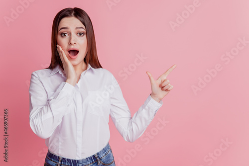 Photo of young girl amazed hand touch cheek point finger empty space advertise direct isolated over pink color background