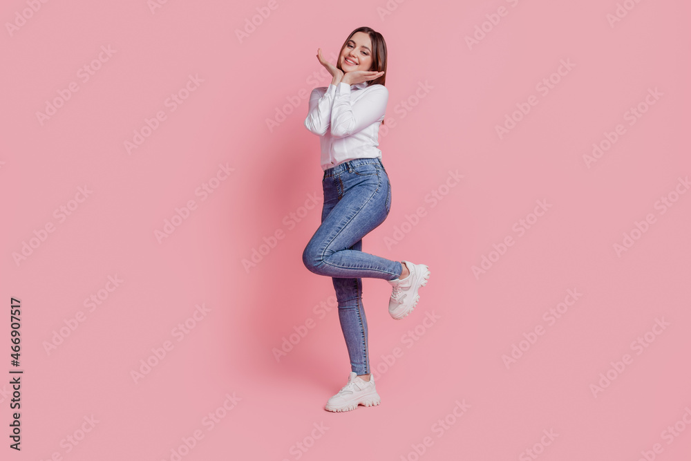 Full length profile side photo of young attractive lady hands touch chin isolated over pink color background Full length profile side photo of young attractive lady hands touch chin isolated over pink color background