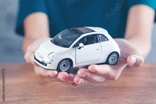 woman holding a toy car in her hands