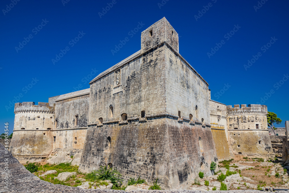 The small fortified village of Acaya, Lecce, Salento, Puglia, Italy. The large stone-paved square. The ancient medieval castle with towers and moat.