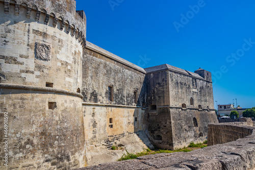 The small fortified village of Acaya, Lecce, Salento, Puglia, Italy. The large stone-paved square. The ancient medieval castle with towers and moat.