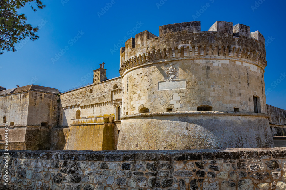 The small fortified village of Acaya, Lecce, Salento, Puglia, Italy. The large stone-paved square. The ancient medieval castle with towers and moat.