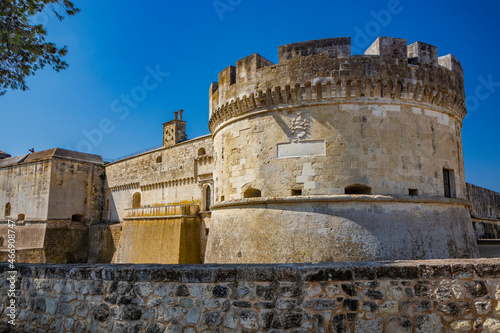 Fototapeta Naklejka Na Ścianę i Meble -  The small fortified village of Acaya, Lecce, Salento, Puglia, Italy. The large stone-paved square. The ancient medieval castle with towers and moat.