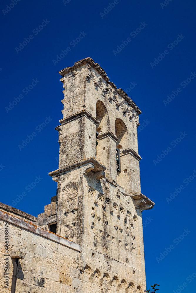The small village of Acaya, Lecce, Salento, Puglia, Italy. The church of Santa Maria della Neve, in baroque, neoclassical and Romanesque style. The back with the bell tower.