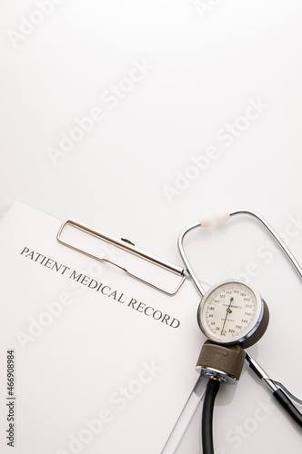 Patient medical record on clipboard with stethoscope. white copy space