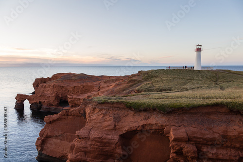 The 1874 Borgot lighthouse located on immense red sandstone cliffs at Cap Hérissé during a fall sunset, Cap-aux-Meules, Magdalen Islands, Quebec, Canada photo