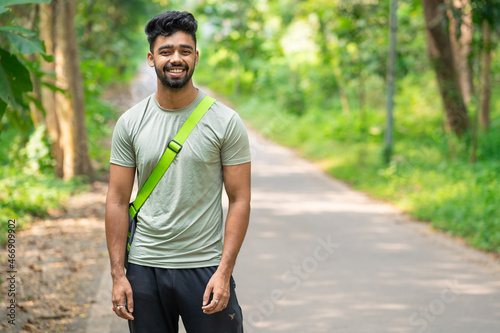 Young cheerful man holding fitness sports bag. © Arnav Pratap Singh