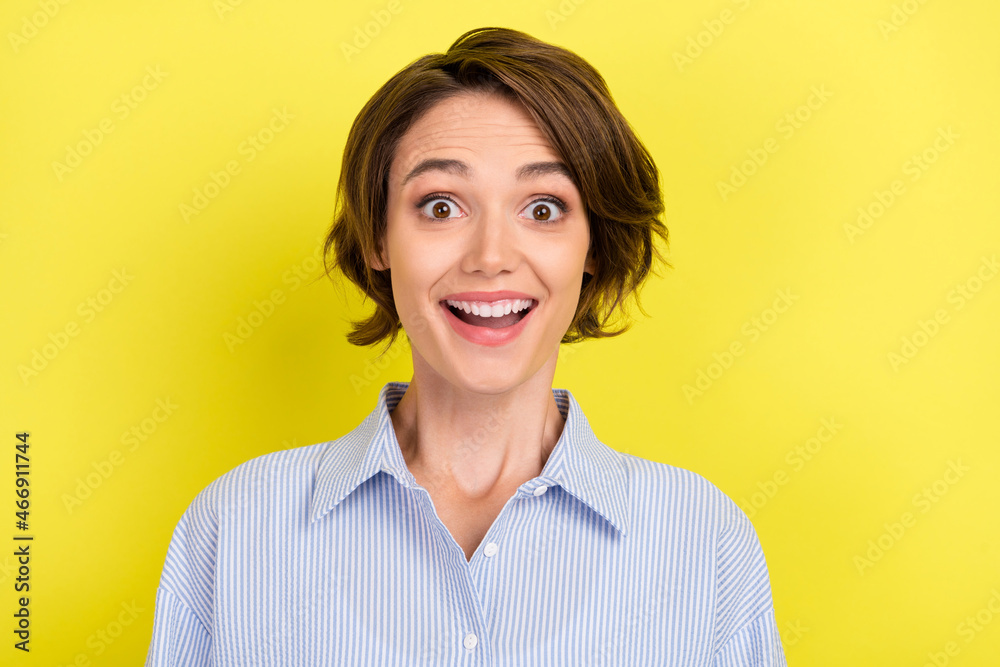 Photo of young excited woman happy positive smile amazed news wow isolated over yellow color background Photo of young excited woman happy positive smile amazed news wow isolated over yellow color background
