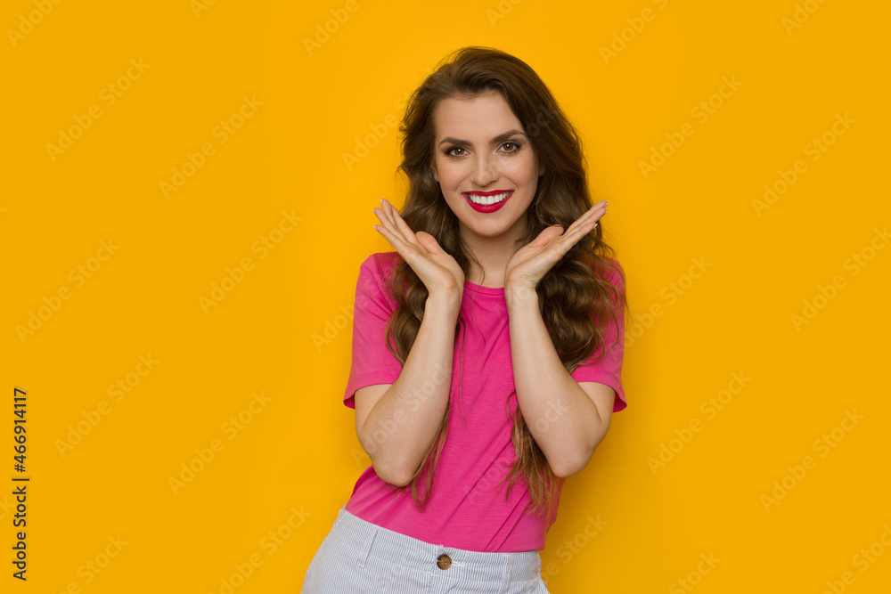 Fototapeta premium Beautiful smiling woman is posing with head in hands.