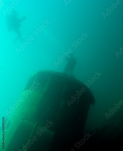 Diver saluting while on a tugboat shipwreck in Lake Superior