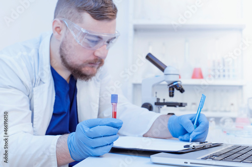 Virologist doctor make a blood test with sample in laboratory. Covid-19 blood test concept