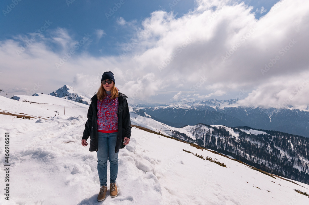 redhead girl in snowy mountains