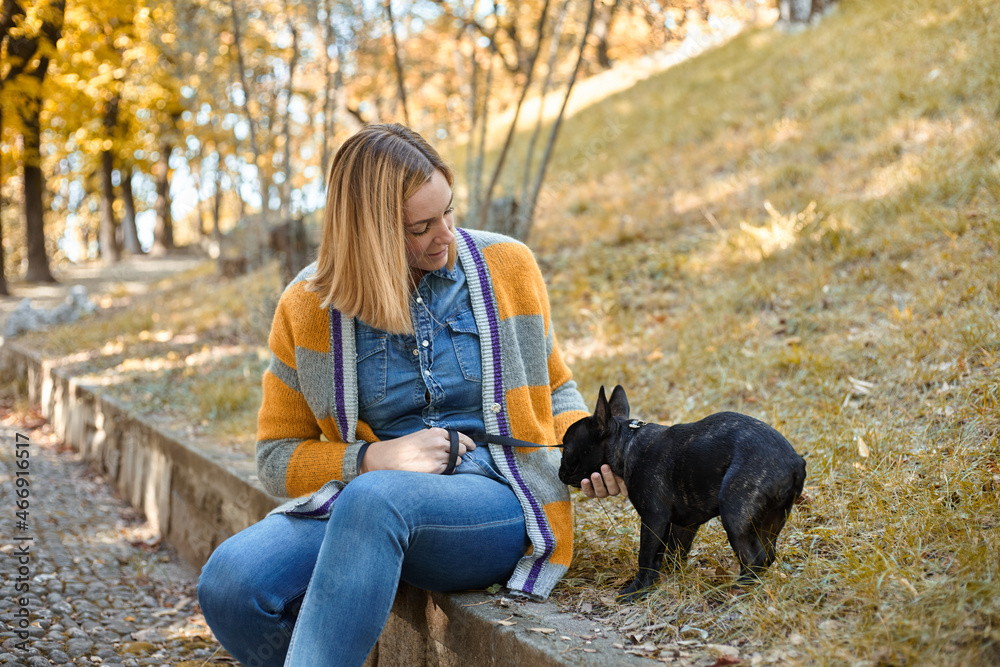Closeup on happy young woman with dog outdoors in autumn Closeup on happy young woman with dog outdoors in autumn