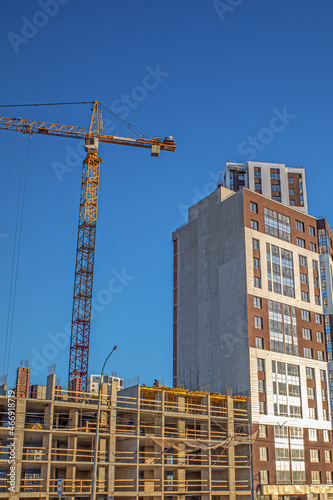 Construction of an apartment building on a blue sky background