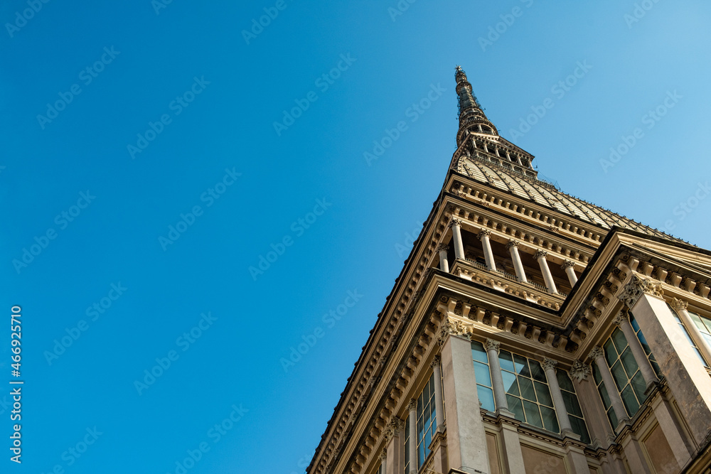 Mole Antonelliana landmark monument of Turin city close up view from below with copy space and clear blue sky. popular landmark building and example of italian architecture and travel destination