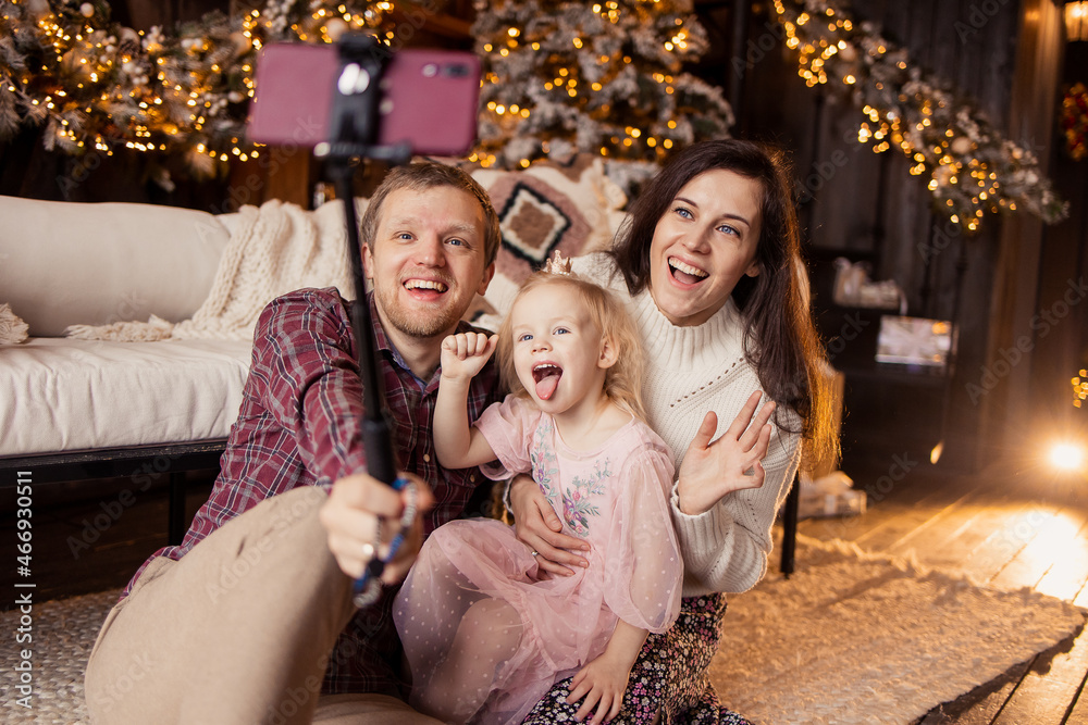 Happy Family celebrate Christmas online. video call for the new year greeting. Decorated house for christmas eve. Selfie Remote communication. Lifestyle live funny photo. Togetherness. Happy Family celebrate Christmas online. video call for the new year greeting. Decorated house for christmas eve. Selfie Remote communication. Lifestyle live funny photo. Togetherness.