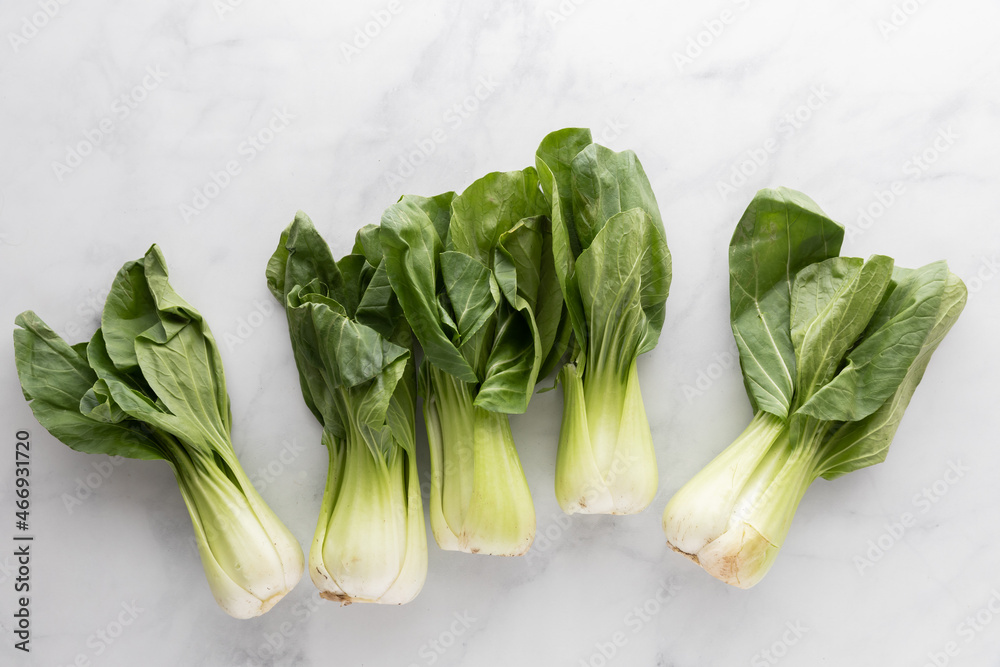 Bok choy clusters on a marble table, from above. Bok choy clusters on a marble table, from above.