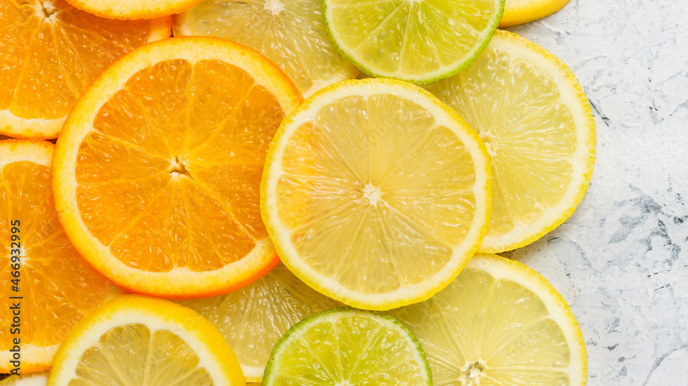 Background with sliced citrus fruits. Sliced lemons, oranges and limes top view