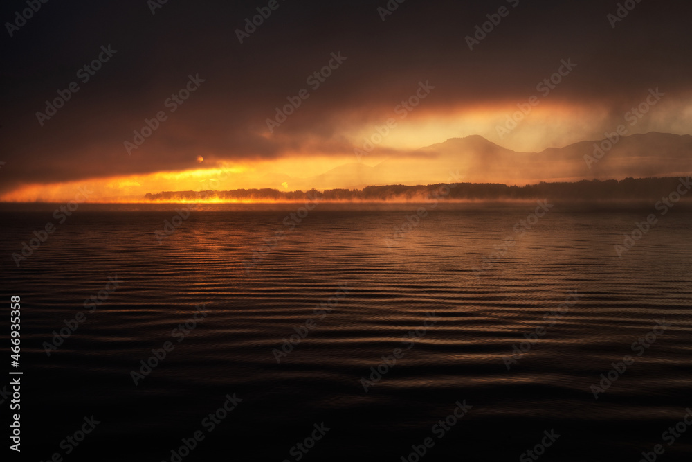 Sunrise and dark misty weather over the lake Liptovska Mara at Slovakia