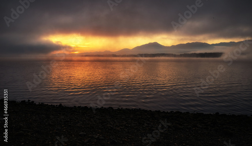 Colorful sunrise over morning lake