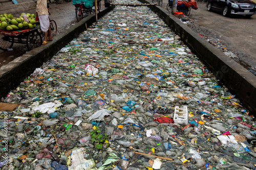 The mouth of the canal is blocked by piles of plastic waste and food waste dumped in the city of Jatrabari, Dhaka.