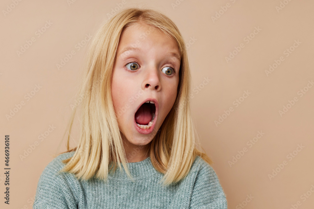 happy child with blond hair posing studio