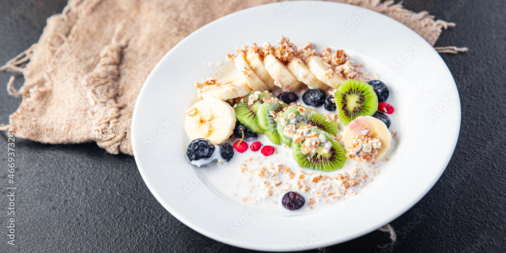 oatmeal breakfast bowl fruit vegetable milk, gluten free, lactose free, banana, kiwi, berrie, blueberrie meal snack on the table copy space food background rustic 