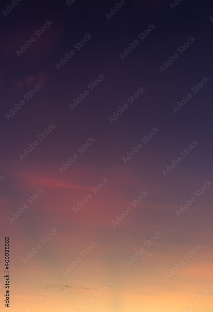 Dusk sky vertical with colorful orange sunlight in the evening on golden hour
