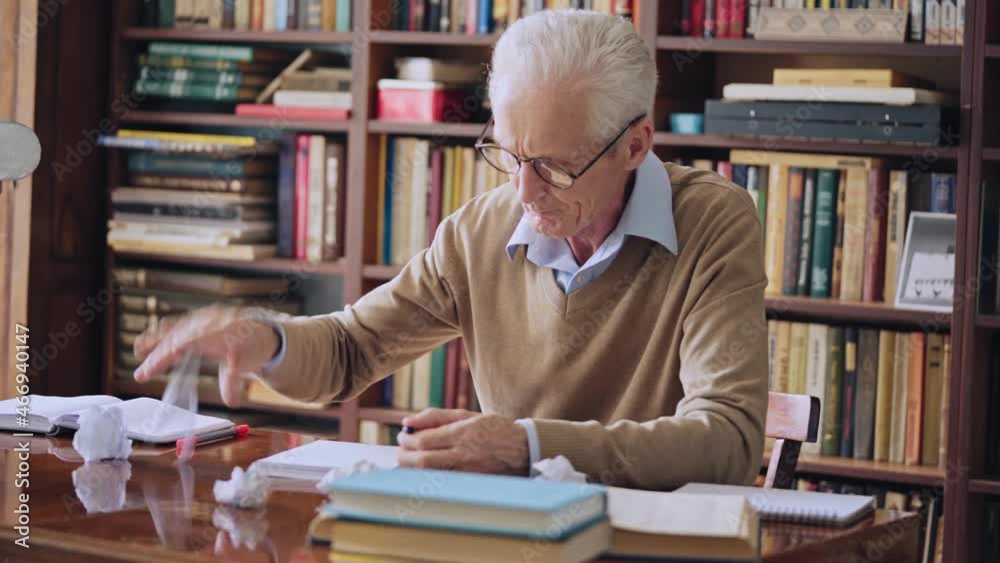 Upset male writer trying to think of new ideas, cramping paper, unsatisfied Upset male writer trying to think of new ideas, cramping paper, unsatisfied