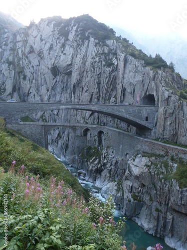 World famous Teufelsbrücke (devil's bridge) road bridge across river Reuss and Urnerloch road tunnel in Schöllenenschlucht (Schöllenen Gorge), Andermatt, Uri, Switzerland
