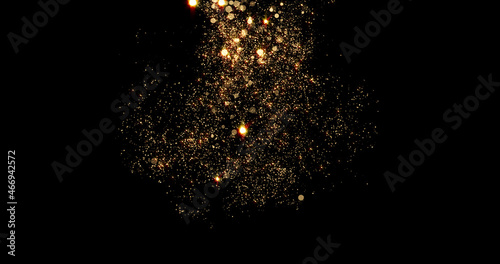 Gold particles flow or golden smoke background with glitter fragrance and shimmer glow. Golden particles and glitter spray effect with magic light flares photo