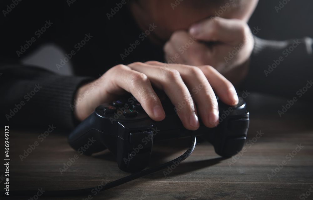 Caucasian man holding joystick. Game. Addiction