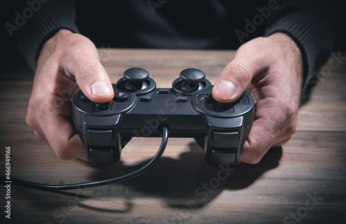 Caucasian man holding joystick. Game. Addiction