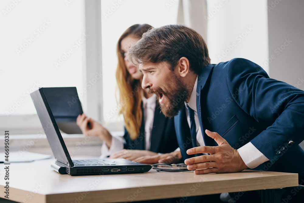 business man and woman sitting in front of a laptop teamwork professionals business man and woman sitting in front of a laptop teamwork professionals