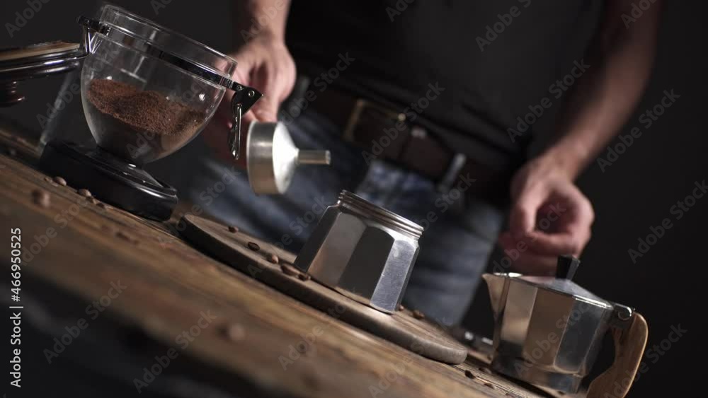 Preparation of delicious black coffee Italian moka. Geyser coffee maker on a wooden table on a dark background. Preparation of delicious black coffee Italian moka. Geyser coffee maker on a wooden table on a dark background.