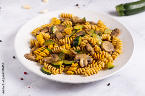 Fusilli pasta with mushrooms and zucchini.