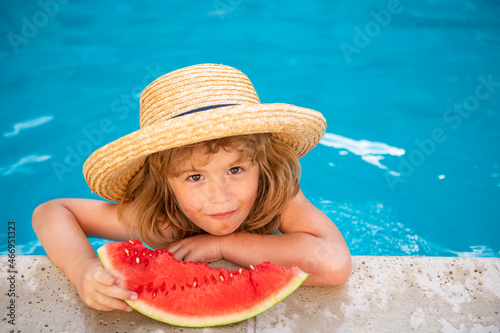 Child with watermelon in swimming pool. Kids eat summer fruit outdoors. Healthy children.