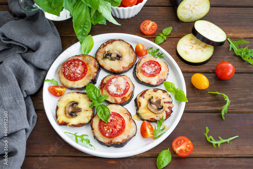 Eggplant pizza with tomatoes sauce, mozzarella, mushrooms and fresh basil. Vegetarian dish. Selective focus