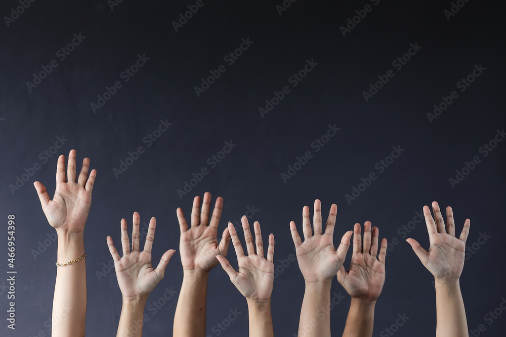 Hands raising on grey background
