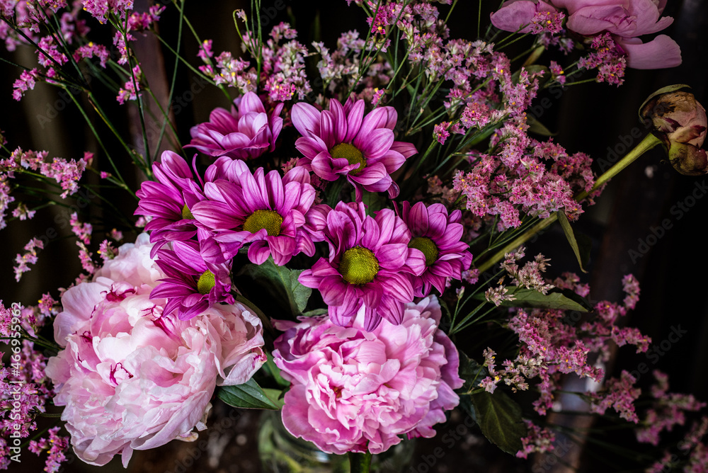 Bouquet of flowers on shabby chair