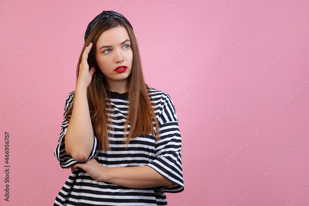 Portrait of young cute girl looking away and thinking about life isolated on light pink studio background. Concept of emotions, fashion Portrait of young cute girl looking away and thinking about life isolated on light pink studio background. Concept of emotions, fashion