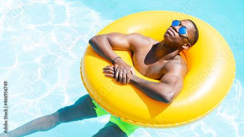 Relaxed black man on inflatable ring photo