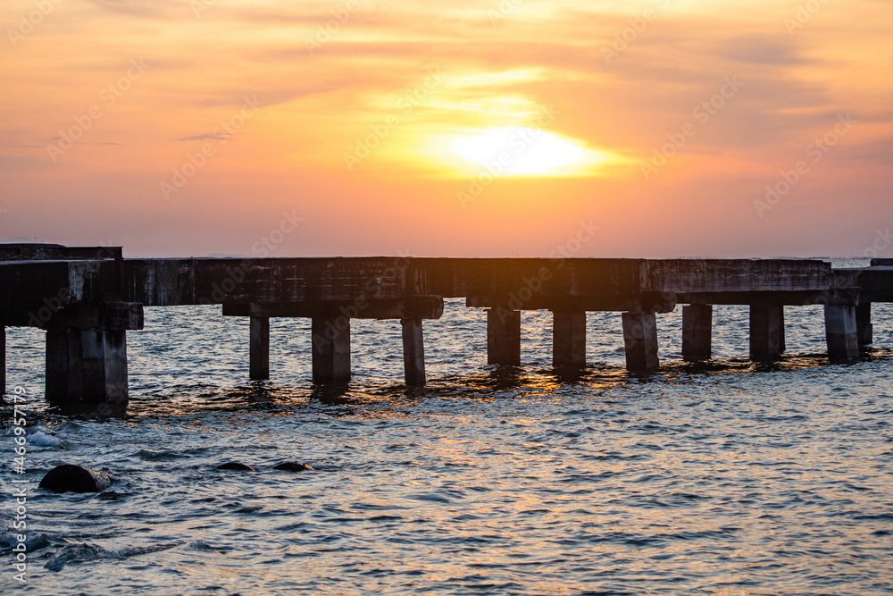 Obraz premium Abandoned bridge in the middle of the sea during sunset at Chittaphawan Temple, Chonburi Province, Thailand