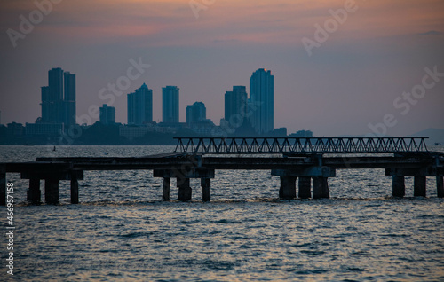 Abandoned bridge in the middle of the sea during sunset at Chittaphawan Temple, Chonburi Province, Thailand © Chay