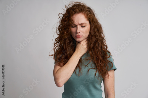 Young woman with serious sore throat photo