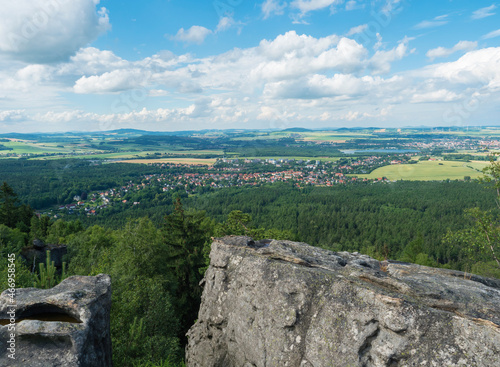 View from hill Topfer sandstone viewpoint near Oybin with view of Zittau town at Poland German borders in Zittauer Gebirge mountains, Saxony, germany. Summer sunny day, blue sky, white clouds