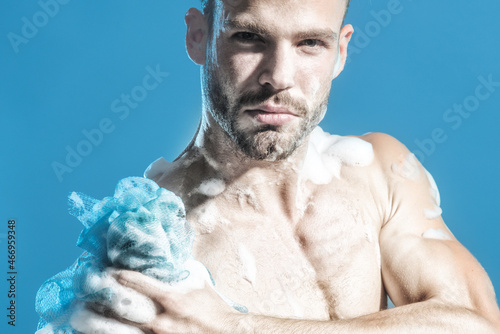 Sexy unshaved man taking shower to cleanse body after tired and stressed from work. Man having relaxing shower.