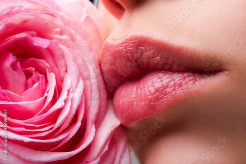 Lips with lipstick closeup. Beautiful woman lips with rose, macro with beautiful mouths.